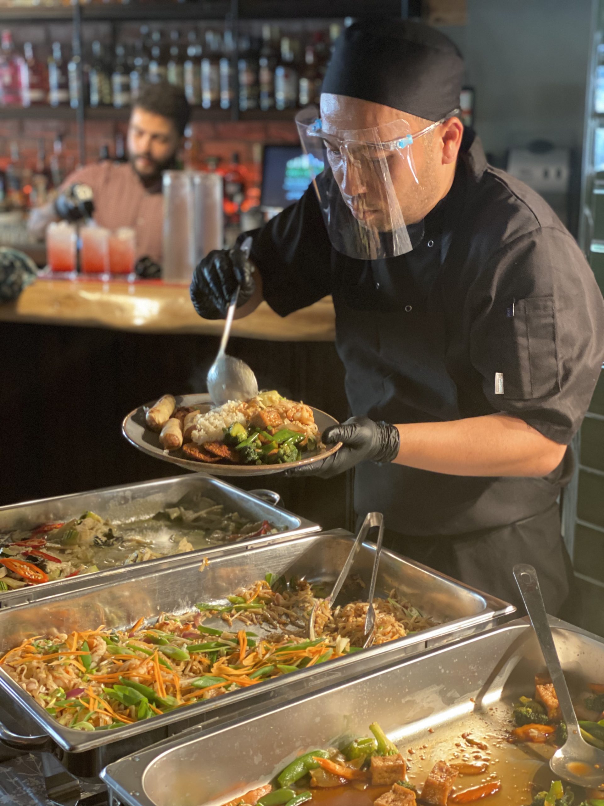 Thai restaurant owner serves food with PPE