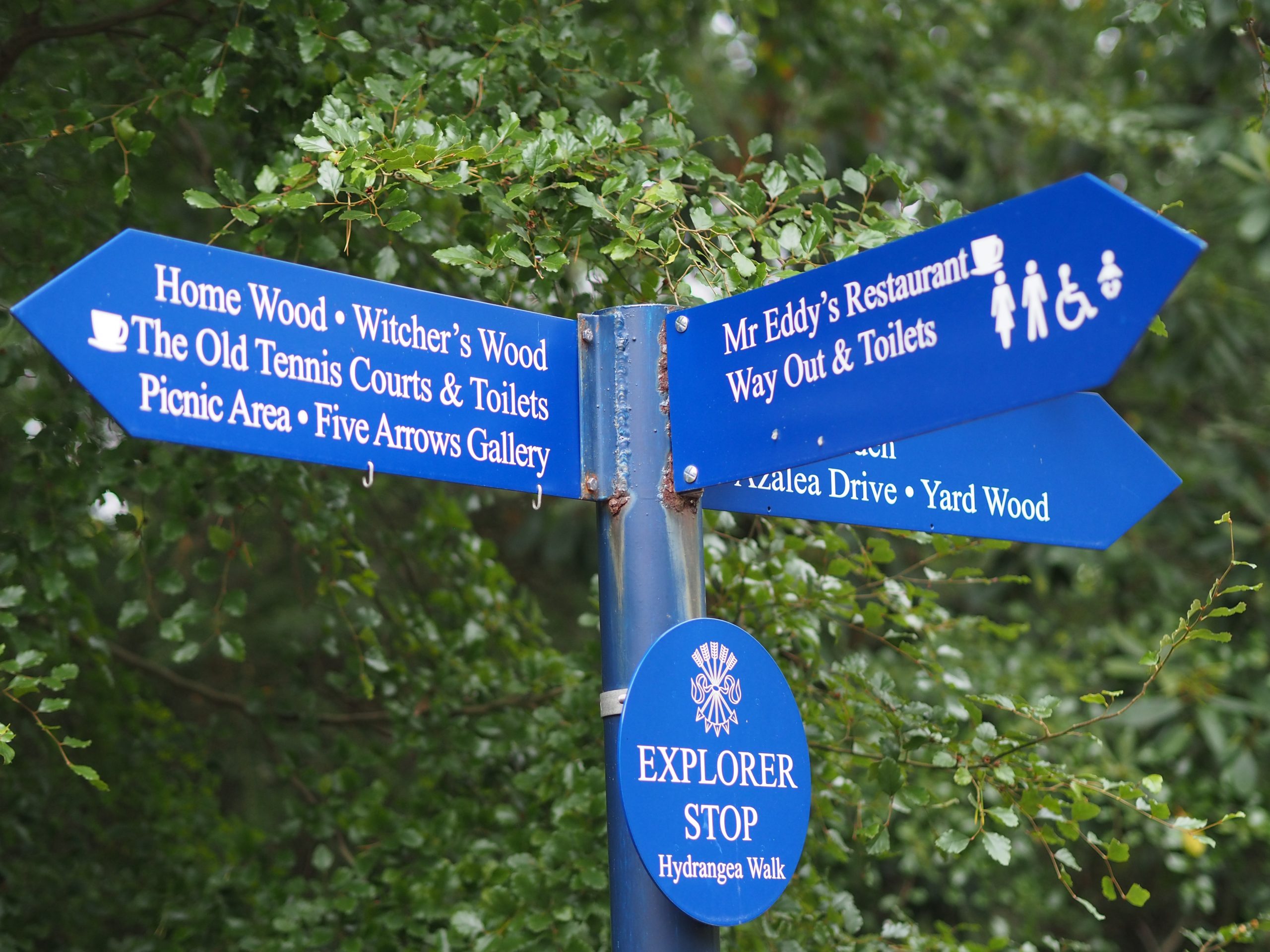 signs pointing to various gardens 